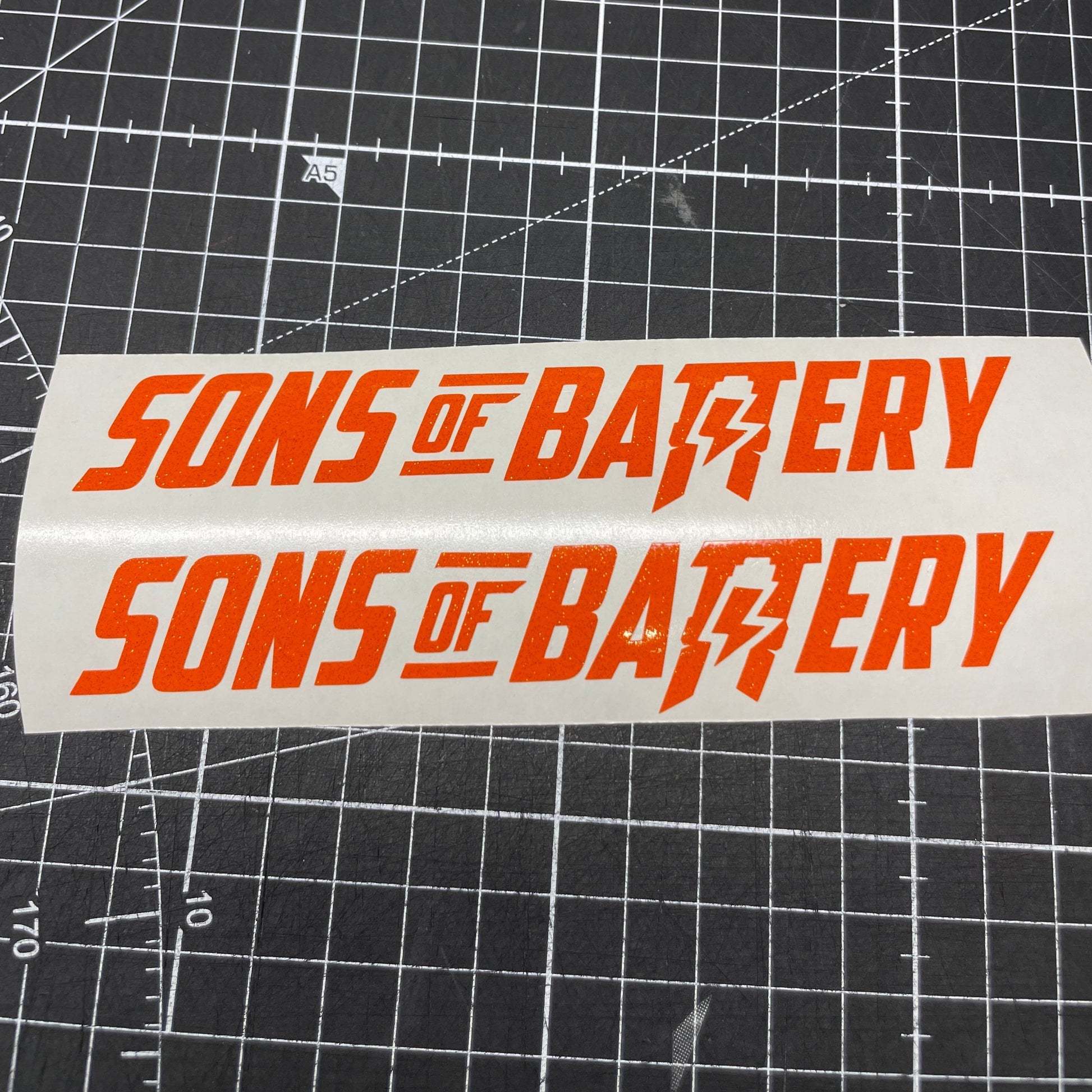 Sons of Battery - E-MTB Brand & Community Folien Orange (Glitzer) / 9 x 1.6 cm Sons of Battery - Schriftzug Modern E-Bike-Community